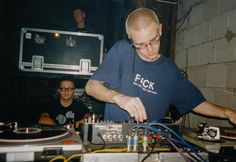 two men are working on some electronic equipment