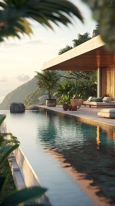 an outdoor swimming pool with lounge chairs overlooking the water and mountains in the background at sunset