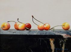 four cherries sitting on top of a black marble slab with white wall in the background