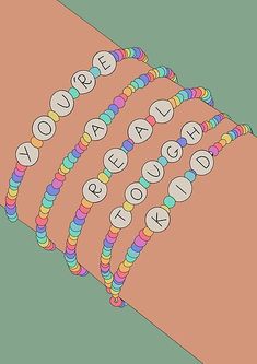 a person's arm with four bracelets on it that spell out the word beaded