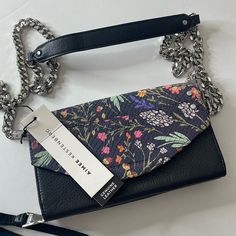 Aimee Kestenberg Delancey Wallet On A Chain Black Floral Leather Silver Brand New With Tags ($188). Excellent New Condition. Put The Bulky Bag Away. When All You Need Is Some Cash, Cards, And Id, Carry It Smartly In This Lightweight Leather Wallet. The Removable Chain Strap Means You Can Slip It Stylishly Over Your Shoulder Or Pop It In Your Purse (For Bigger Shopping Excursions). From Aimee Kestenberg. Style: Delancey Removable Chain Strap, Magnetic Snap Closure, Gunmetal Or Goldtone Hardware I Everyday Wallet On Chain With Palladium Hardware, Silver Wallet On Chain For Everyday Use, Interior Fabric, Pop It, Leather Silver, Chain Strap, All You Need Is, Black Floral, Snap Closure