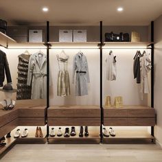 a walk in closet filled with lots of shoes and clothing hanging on the wall next to wooden shelves