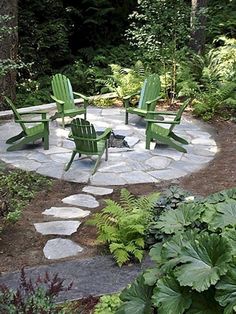 a fire pit surrounded by lawn chairs and plants