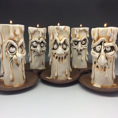 there are five candles that have been decorated to look like halloween characters with faces on them