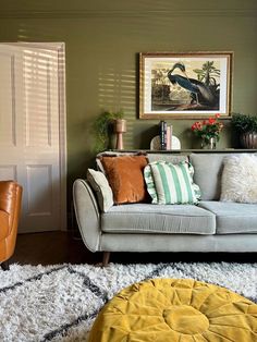 a living room with two couches, a chair and a rug on the floor