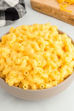 a bowl filled with macaroni and cheese on top of a table