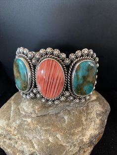 Masha Indian Native American Jewelry -On Route 66 - Albuquerque, New Mexico U.S.A Item Specifics * Stone : Royston Turquoise & Spiny Oyster * Size : 5.5" * Gap : 1.15" * Top Measurements : 2.5" * Color : Blue & Red * Artisan : Harold Joe * Free gift with Purchases (Till Stocks Last)   Genuine Sterling Silver Jewelry This beautiful piece of jewelry is made from all 925 Sterling Silver. These specimens are handmade by the artist creating the perfect balance of fall, color and shine. Whether you are just starting out or are a serious collector you will not be disappointed with this work of art. Authenticity you can Trust We have been in this industry since 1972, all of our Jewelry is Authentic Artisan Handcrafted Sterling Silver. It is Designed, Manufactured, Finished, Polished and Assembled New Mexico Usa, Albuquerque New Mexico, Top Measurements, Native American Artists, Royston Turquoise, Spiny Oyster, Fall Color, American Jewelry, Route 66