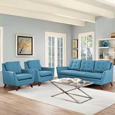 a living room with blue furniture and white rug