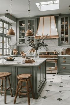 a kitchen with two stools in front of the island and an oven on the other side