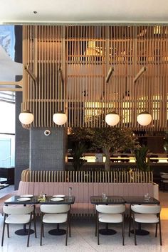 the restaurant is decorated with bamboo screens and white chairs