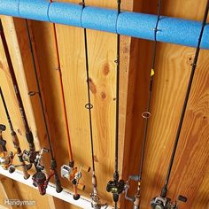 there are many fishing rods hanging on the wall