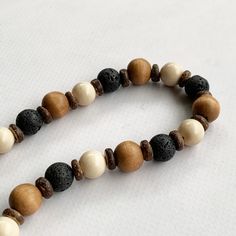 This boho beaded necklace is perfect for everyday wear!  It was hand beaded using a mix of 12mm round tan wooden beads, 10mm round black lava stone beads, 10mm round beige agate gemstones, and wooden rondelles.  The necklace measures approximately 18.5 inches in length and is securely fastened with a silver clasp.  Length can be adjusted if needed - just ask! Wood represents a sense of earthiness, spirituality, creativity, liberty, prosperity, health, and natural touch.  Perfect for meditation, Boho Beaded Necklace, Wooden Bead Necklace, Mens Beaded Necklaces, Necklace Wood, Wooden Bead Necklaces, Necklace Mens, Mens Necklace, Color Necklace, Wood Necklace