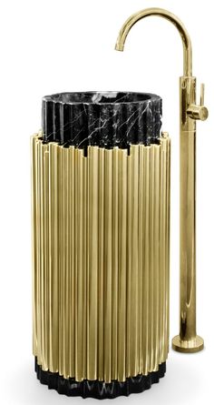 a black and gold toilet brush holder next to a faucet on a white background