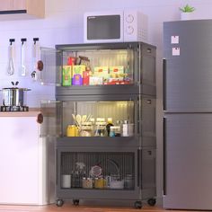 a refrigerator freezer sitting next to a microwave oven on top of a wooden floor