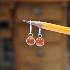 I designed these sterling silver prong settings to be small, wearable and modern. The 8mm carnelian gemstones add a great pop of color and look amazing being held in by the claws of the setting. The dangle measures 7/16 of an inch tall and with the lever backs have a 1 inch drop. Carnelian Round Earrings With Ear Wire, Elegant Silver Carnelian Earrings, Silver Round Carnelian Earrings, Silver Carnelian Jewelry With Ear Wire, Silver Carnelian Drop Earrings, Round Carnelian Gemstone Earrings, Carnelian Gemstone Round Earrings, Orange Gemstone Sterling Silver Earrings, Silver Carnelian Earrings