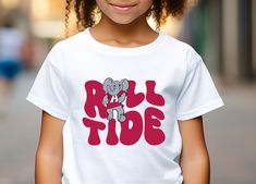 You are going to love the design and quality of this cute Alabama Roll Tide Kids Shirt.  This Bama football Youth shirt will be perfect for your next Alabama Crimson Tide game day! PRODUCTION TIME: 1-3 days (Usually 2 days) SHIPPING TIME: 2-5 days (Usually 3 days) PRODUCT DESCRIPTION: Gildan 5000B Kid/Youth T-shirt -100%, midweight (5.3 oz/yd² (180 g/m US cotton  - Polyester is included for heather-color variants -Classic Fit Tee -Tear-away label -Collar is curl resistant due to ribbed knitting -No seams along the sides CARE INSTRUCTIONS: Wash item inside out in cold water, do not bleach, do not dry clean, do not iron directly on the design. Tumble dry low. Alabama Football Shirts, Alabama Shirt, Alabama T Shirts, Alabama Shirts, Bama Football, Football Lover, Alabama Roll Tide, Football Tee, Youth Shirt