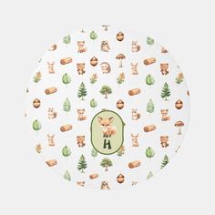 a white plate with woodland animals and trees on it's side, in front of a green circle