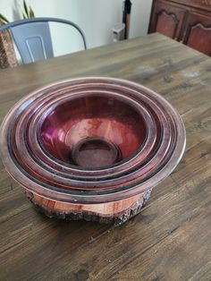 three bowls sitting on top of a wooden table