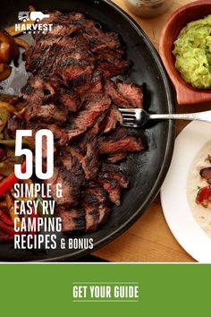 a grill with steak and vegetables on it next to a bowl of guacamole