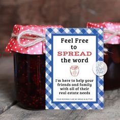 two jars filled with jam sitting on top of a wooden table