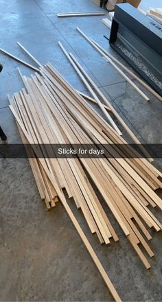 several pieces of wood sitting on the floor next to each other in front of boxes