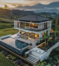 an aerial view of a house with a pool in the foreground