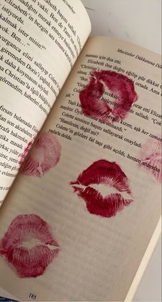 an open book with red lipstick imprints on it