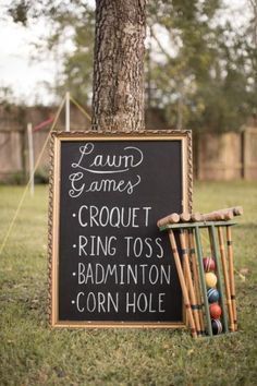 a chalkboard sign that says lawn games croquet ring toss badminton corn hole