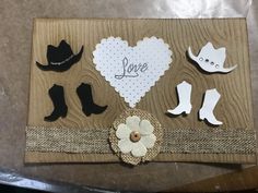 some paper cut outs are laying on top of a piece of cardboard with the word love written in it