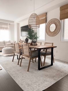 a dining room table with chairs and a potted plant on top of the table