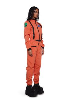 a man in an orange space suit is standing with his hands on his hips and looking at the camera