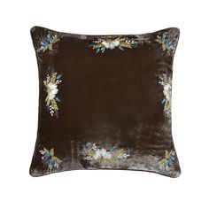 a brown velvet pillow with flowers on it