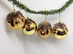 three ornaments hanging from a christmas tree