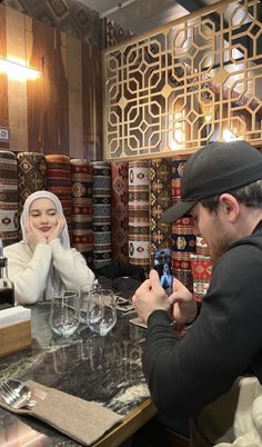 a man and woman sitting at a table in a store