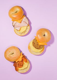 three hamburgers with meat and cheese on them are arranged in the shape of donuts