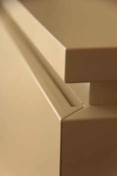 the corner of a white cabinet with no drawers