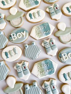 baby shower cookies arranged on top of each other in the shape of houses and buildings