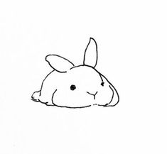 a black and white drawing of a rabbit laying on the ground with its eyes closed