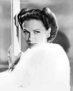 black and white photograph of woman in fur coat