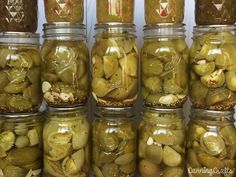 several jars filled with pickles and onions