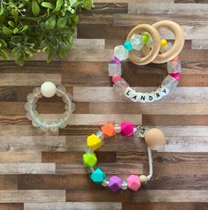 a wooden table topped with lots of toys and greenery next to a potted plant