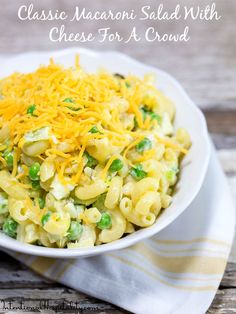 a white bowl filled with macaroni salad and cheese