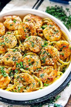 shrimp scampi pasta in a white bowl with parsley on top