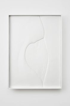 an abstract white artwork piece in a square frame