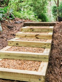 wooden steps made out of wood chips in the middle of some trees and bushes,