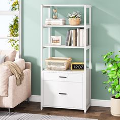 a living room with green walls and a white book shelf next to a couch in front of a window