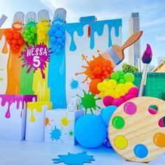 an assortment of colorful paint and brushes on display in front of a backdrop that says hebsa 5