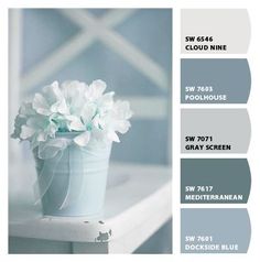 the color scheme is blue, green and gray with white flowers in a vase on a window sill