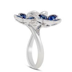 Sapphire petals grow out from a diamond center to form the shape of flowers. Milgrain detailed edges add even more sparkle to this unique design. Diamond Flower Ring, Engagement Rings Bridal Sets, Engagement Ring Guide, Bridal Ring Sets, Diamond Flower, Grow Out, Anniversary Bands, Flower Ring, Sapphire Diamond