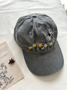 Hand embroidered baseball cap. ★ ABOUT * Cap is %100 cotton and has adjustable bucket. * Floral embroidery is done by hand with cotton thread * All orders are made to order and handmade, therefore embroidery will vary on each unique cap. Every item is unique and one of a kind * Perfect for everyday wear, outdoor activities, etc. * We do custom orders, please contact us for discussion. ★ CARE: * Please refer to here on how to clean baseball cap: https://www.whirlpool.com/blog/washers-and-dryers/h Hand Embroidered Flower, Custom Embroidered Hats, Summer Cap, Flower Hat, Hat Custom, Embroidered Hat, Embroidered Baseball, Embroidered Baseball Caps, Flower Hats